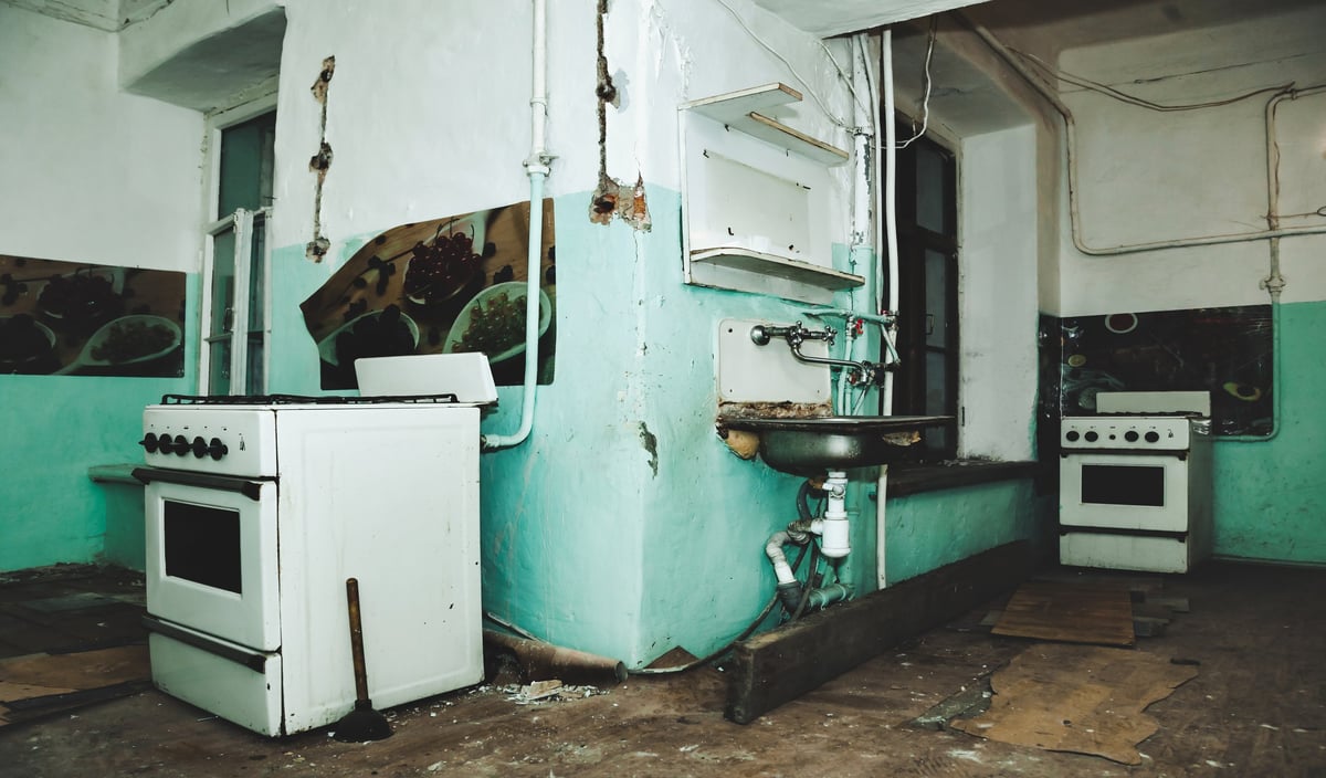 Background of old kitchen interior abandoned apartment with dirty room rotten peeling walls old past renovation concept